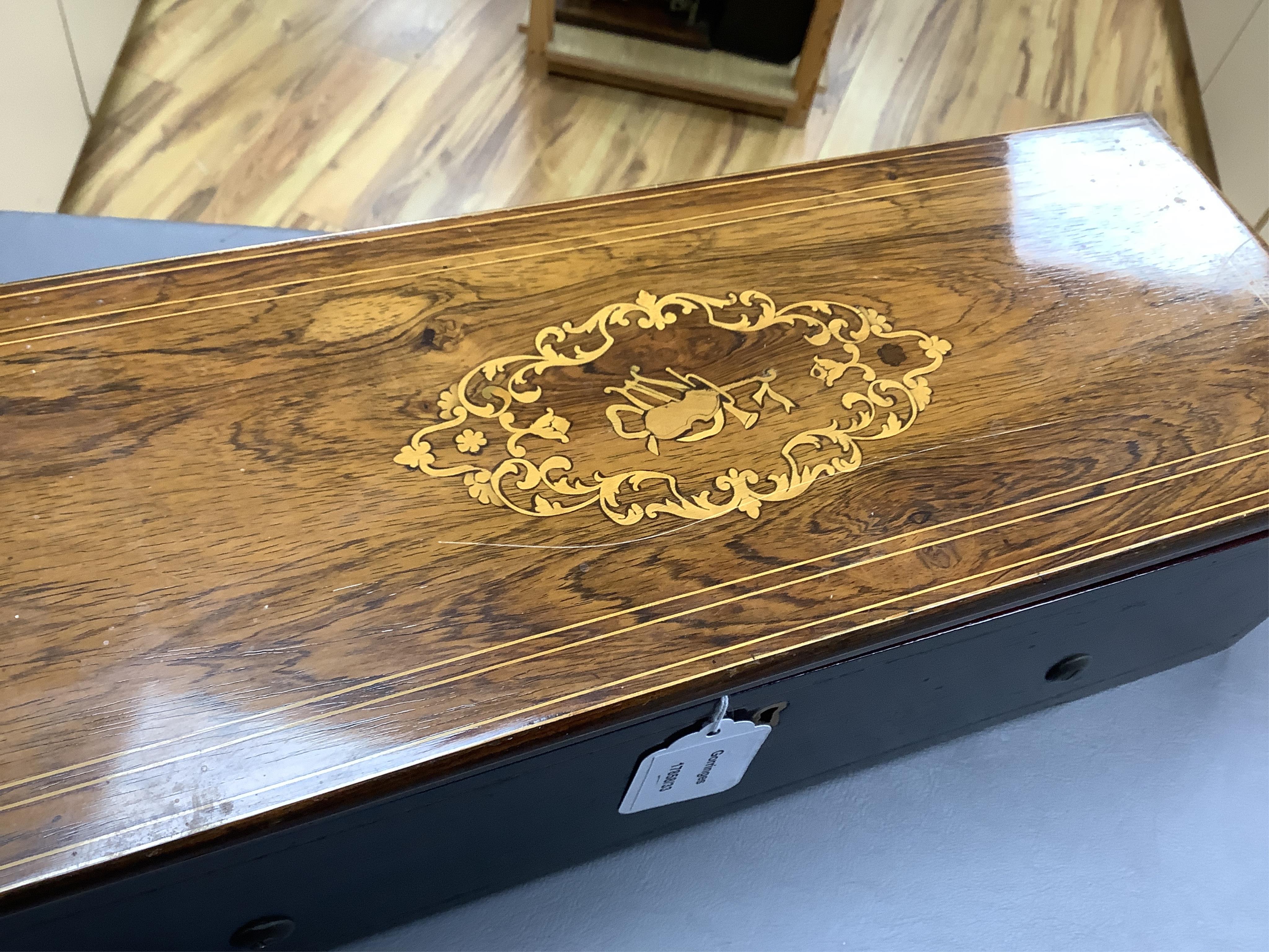 A mid 19th century Nicole Freres key wound cylinder musical box in an inlaid rosewood case, playing on approx 105 tooth comb, cylinder 27.5cm long, stamped ‘Nicole Frere a Geneve’, 26927, with key, the case; 45.5cm wide,